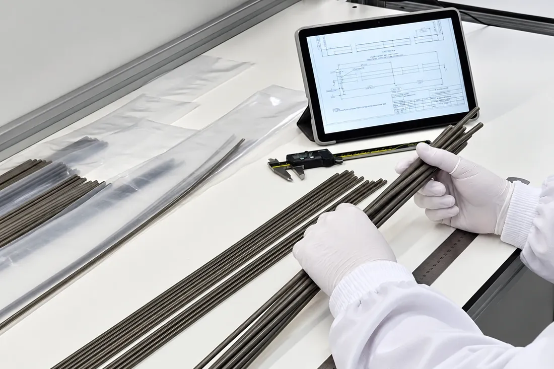 Inspecting reinforced shafts with a digital caliper at a work bench